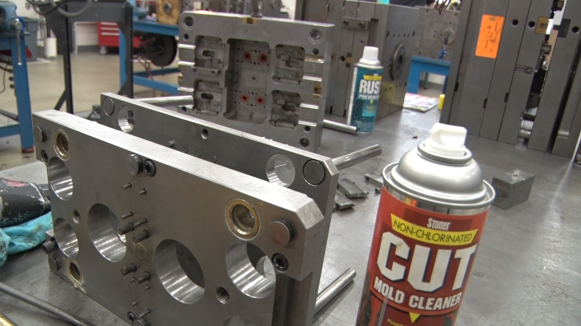 CUT mold cleaner from Stoner Molding sits in front of a clean injection mold.